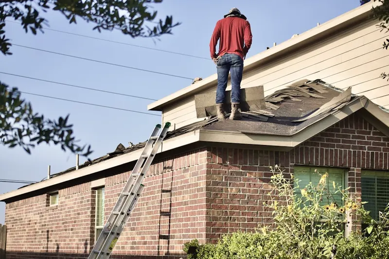 Professional roofer working on a residential roof in Rosemawr